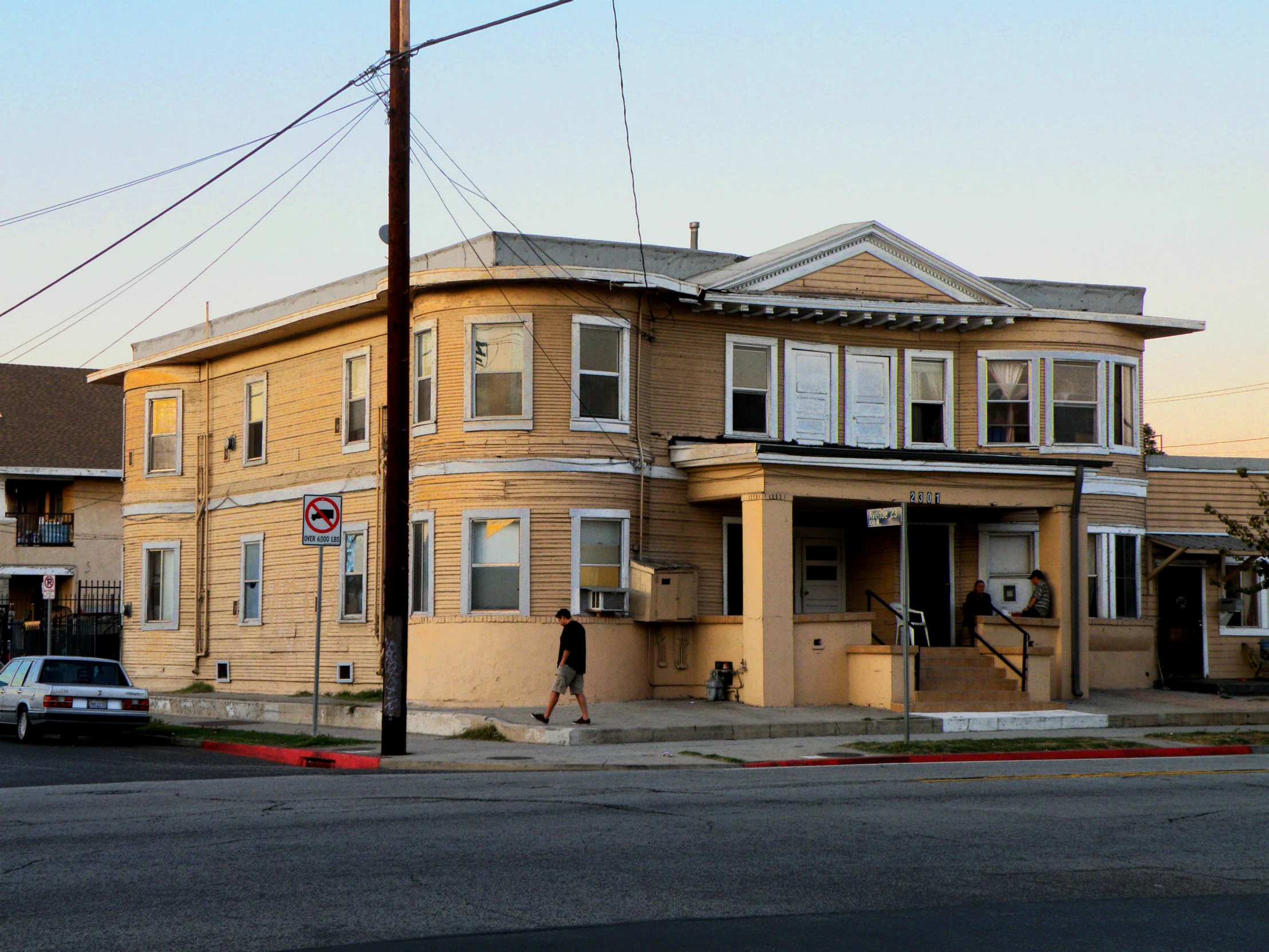 a tan two story home on an intersection