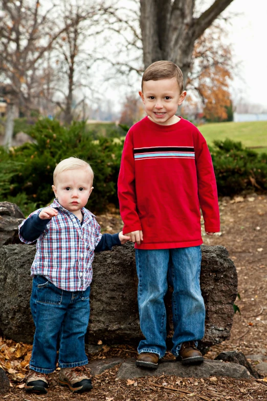 two s pose together in a park