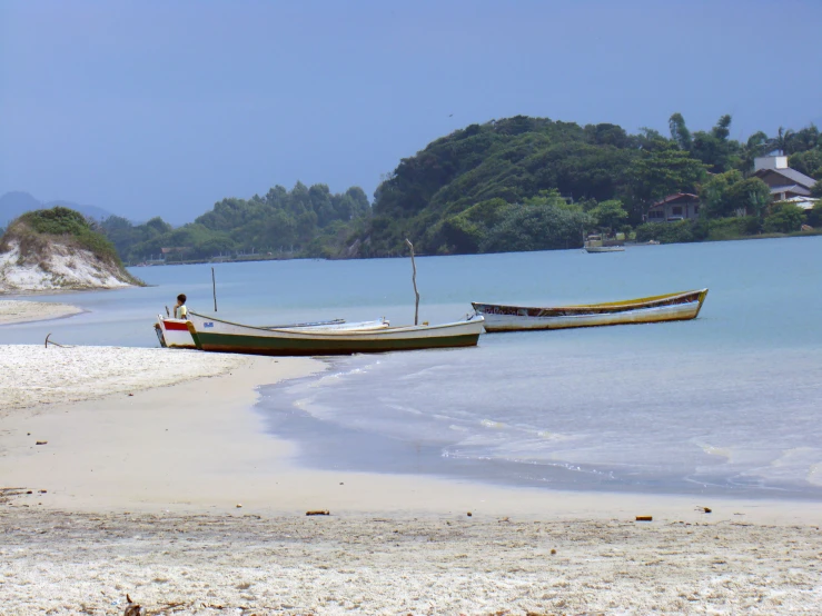 a few boats on the shore of the beach