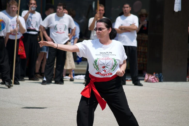 a woman standing in the street while holding onto her arms