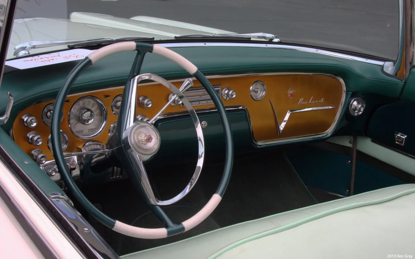 dashboard inside of old classic car with wood trim