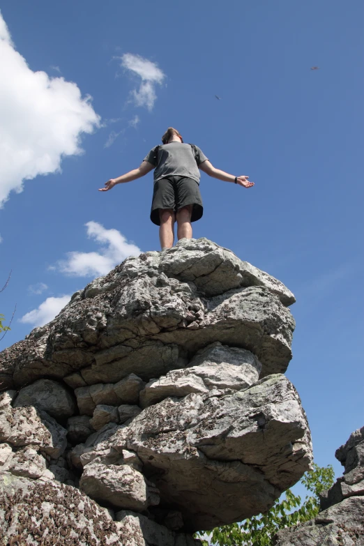 a man standing on top of a rocky outcropping