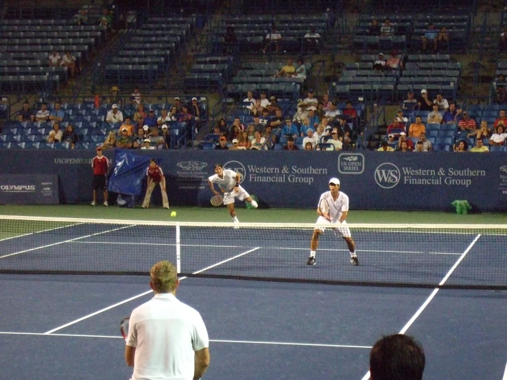 a couple of people playing a game of tennis