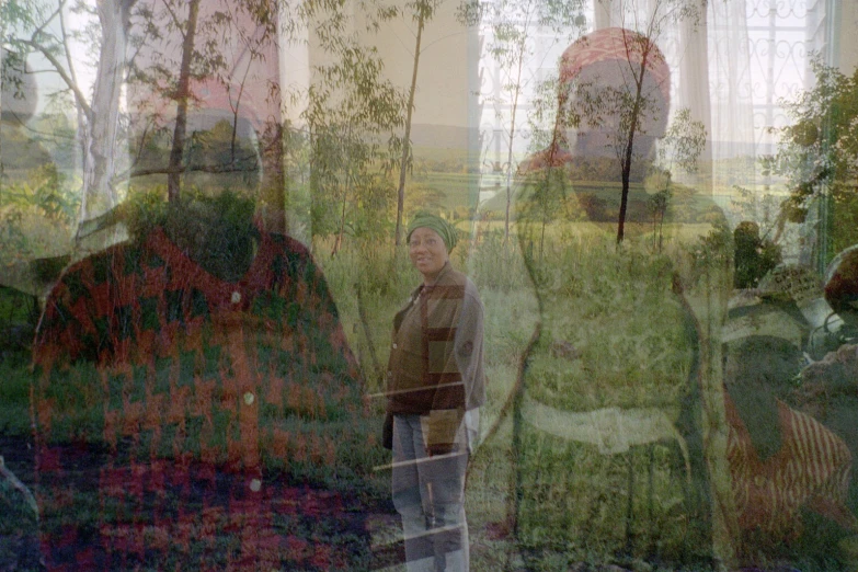 a po of a man looking out of an area where the trees are green