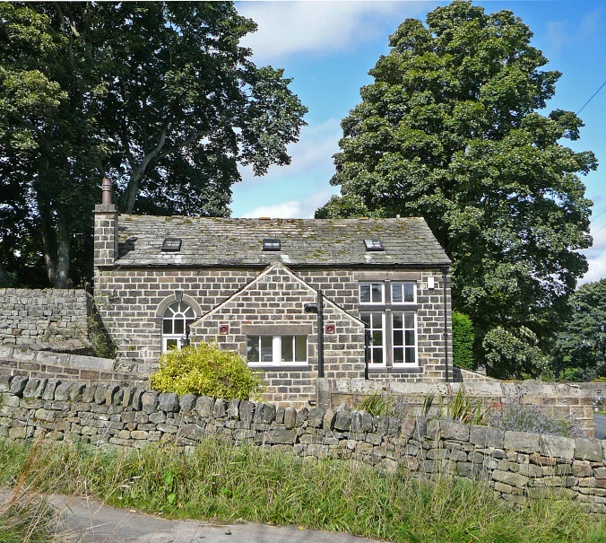 the stone house is set against a brick wall