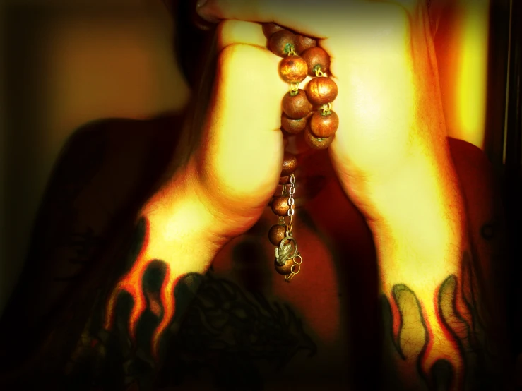 a woman wearing a tattoo and rosary necklace