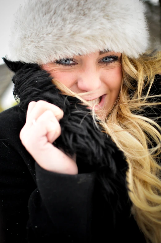 a beautiful blond woman in a fur hat