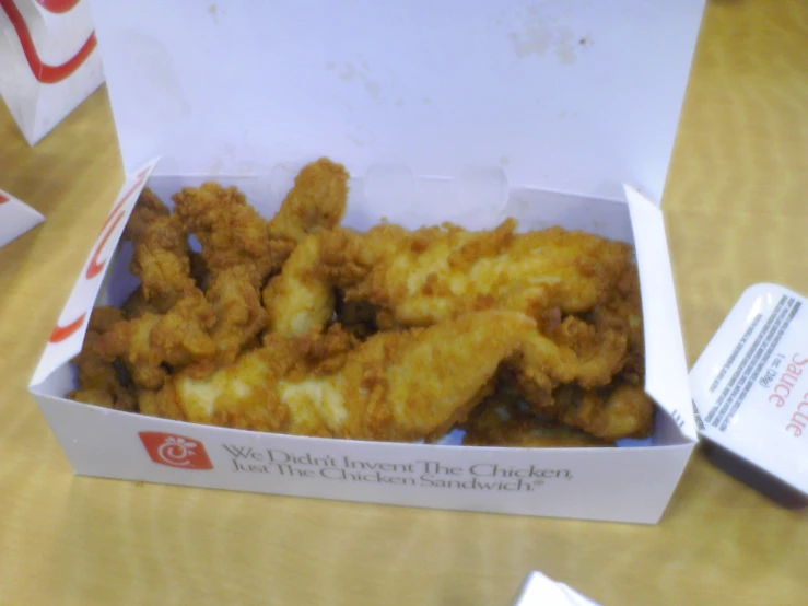 a box is opened filled with fried food