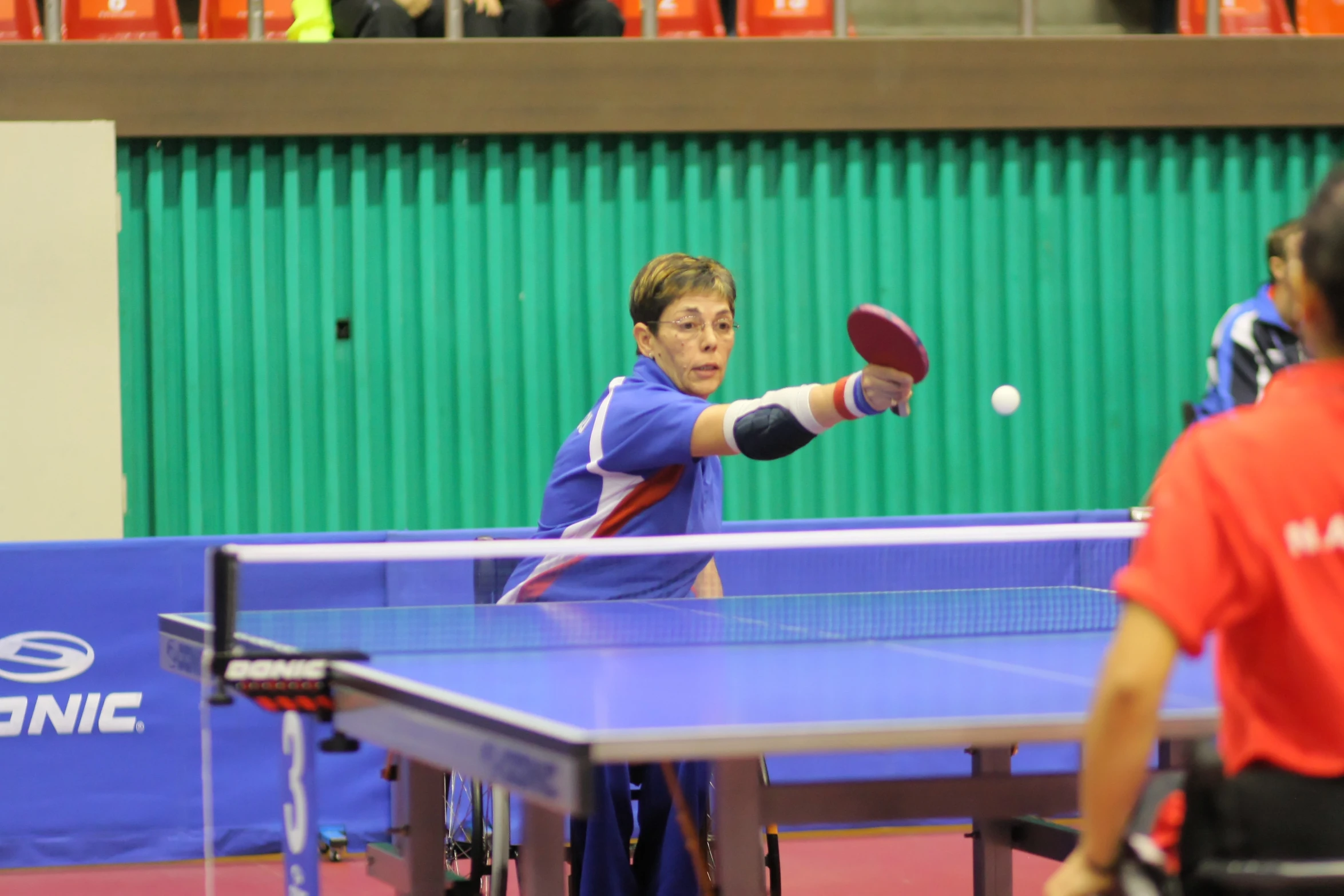 the ping pong player prepares to hit the ball