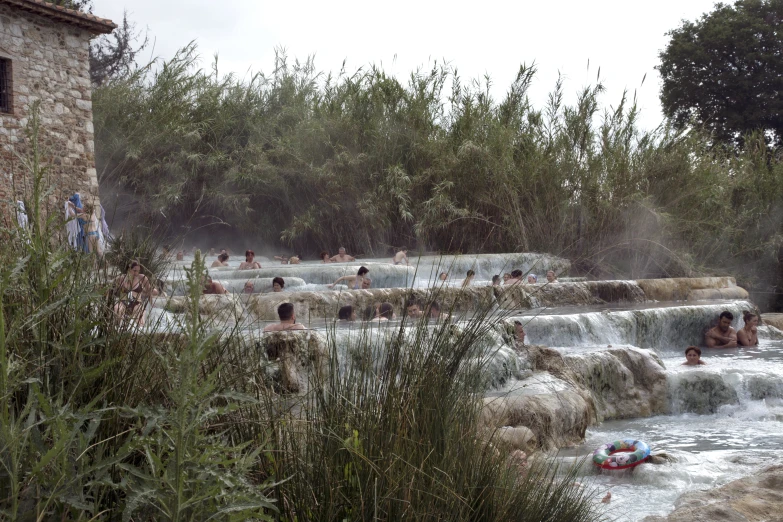 many people are relaxing in  spring water