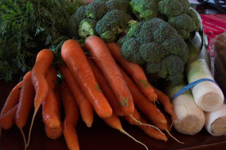 a table filled with lots of fresh vegetables