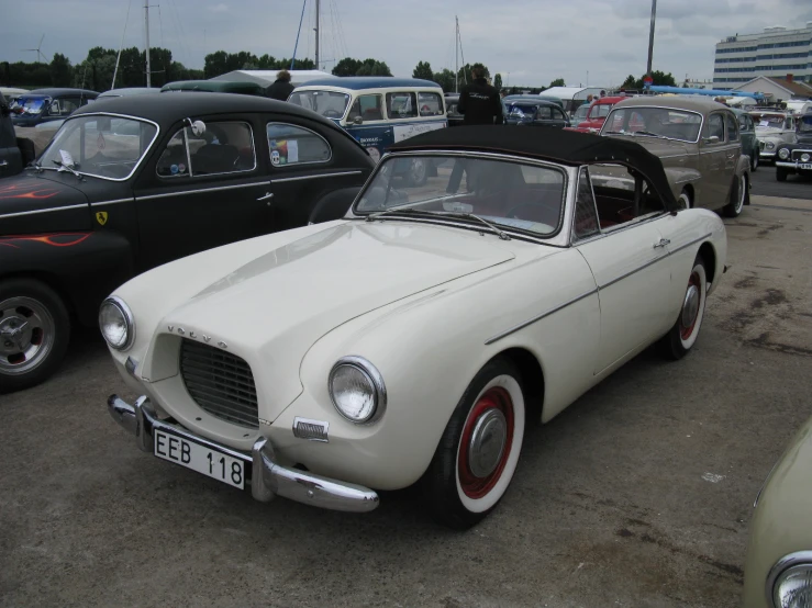 a classic white car with an open roof