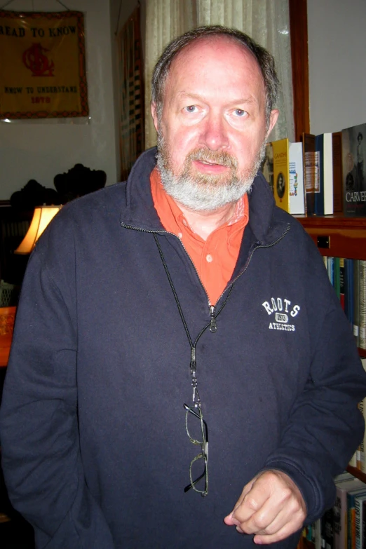 man wearing an orange shirt and a blue hoodie