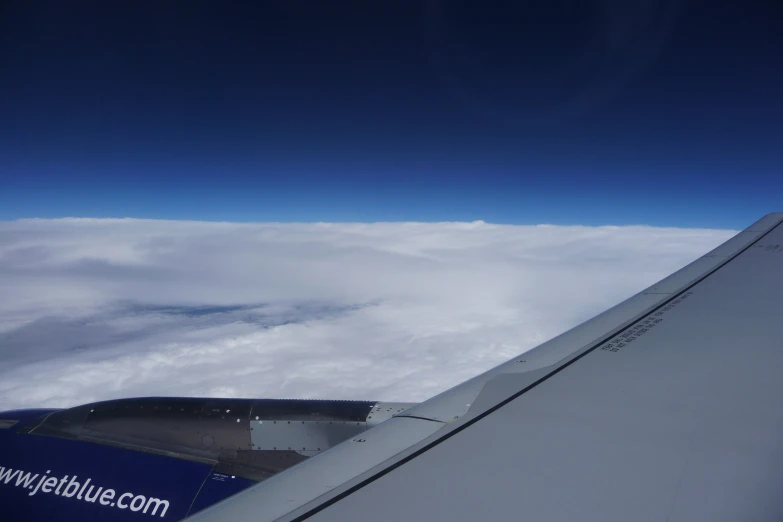 the view from the airplane window shows an upward wing