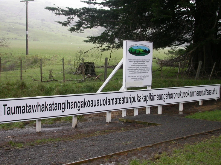 an information sign is displayed in front of train tracks