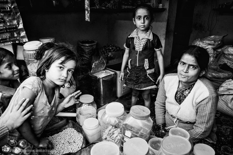 a group of girls sitting around a table in a food house