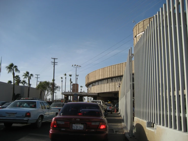 several vehicles are lined up outside of a building