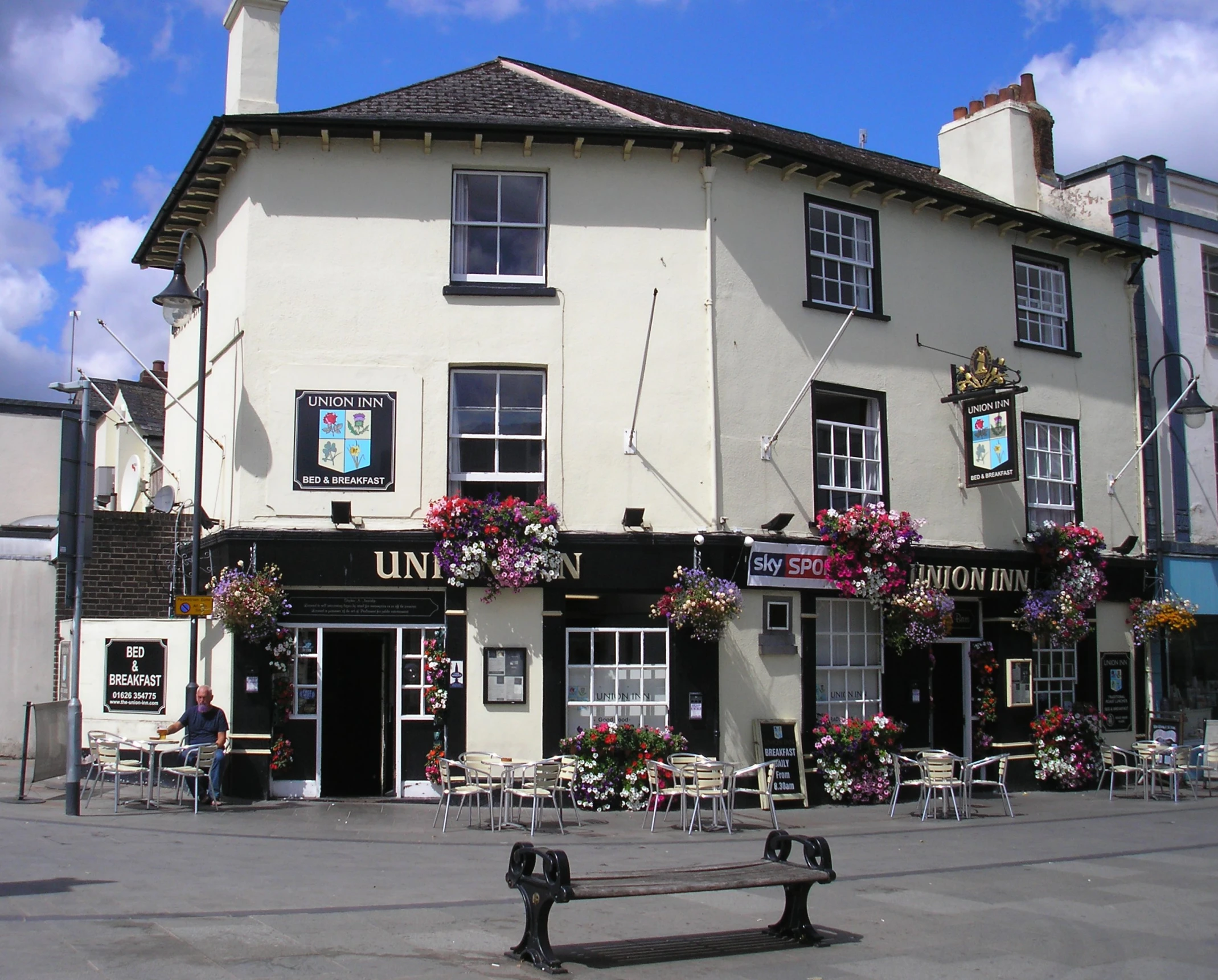 the pub is built into a small white building