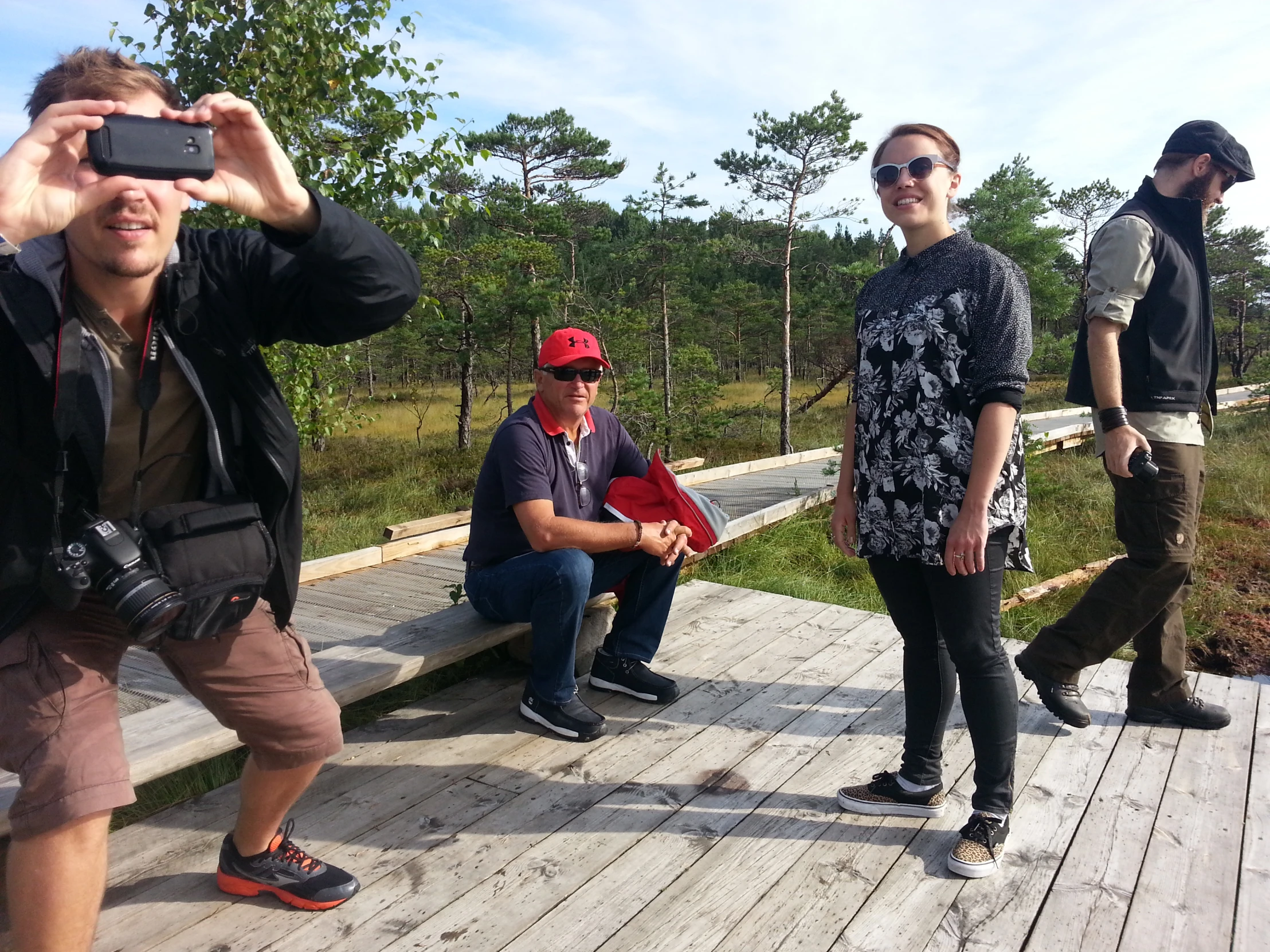 a man is taking pictures on the boardwalk