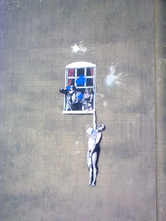 an aerial view of two figures reaching for a basketball hoop