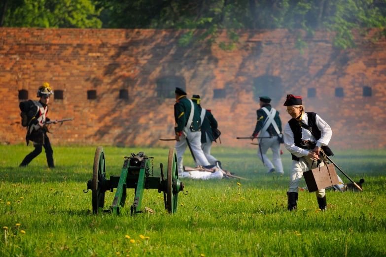 men in uniform with long guns on green grass