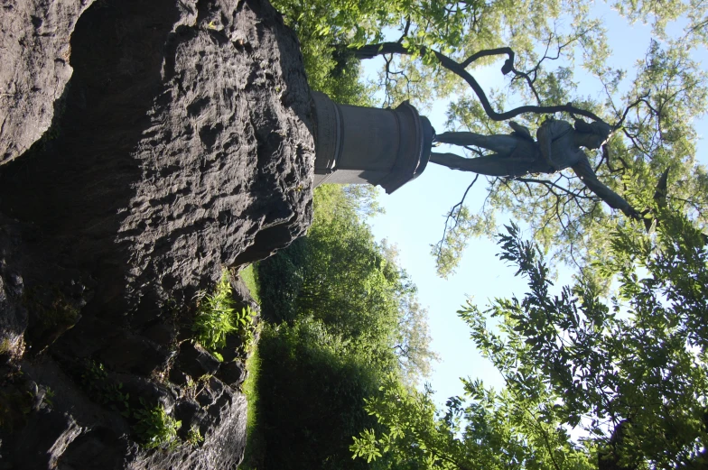 a statue of a man standing on top of a rock