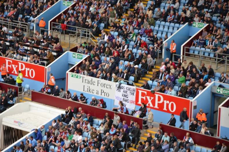 a group of people with signs inside of some empty seats