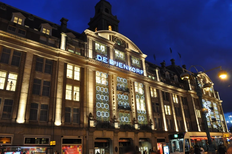 people walking in front of a large building