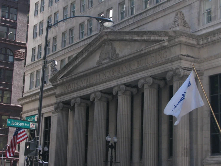 a pole with an american flag next to a building