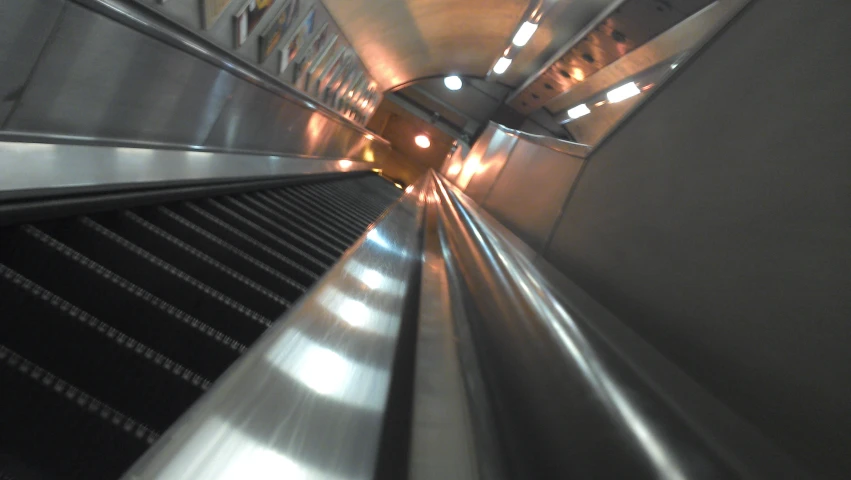 an escalator with people on it at night