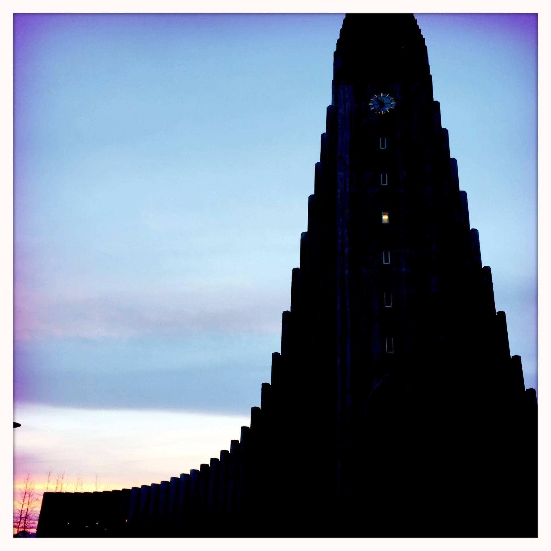 a very tall building with a large clock on it's face