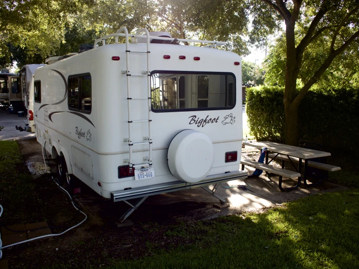 an rv is parked at a picnic table