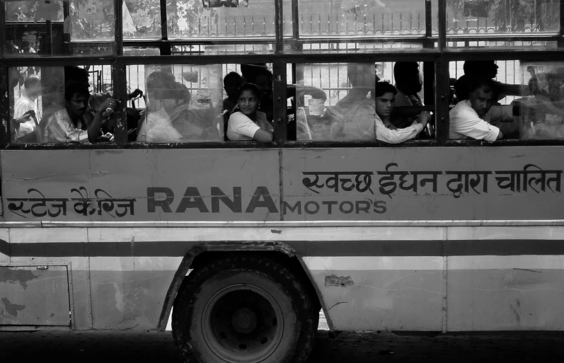 a group of people sitting on the front of a bus