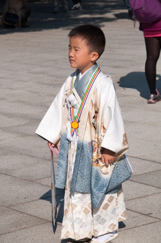 a little boy in costume holding a silver baseball bat
