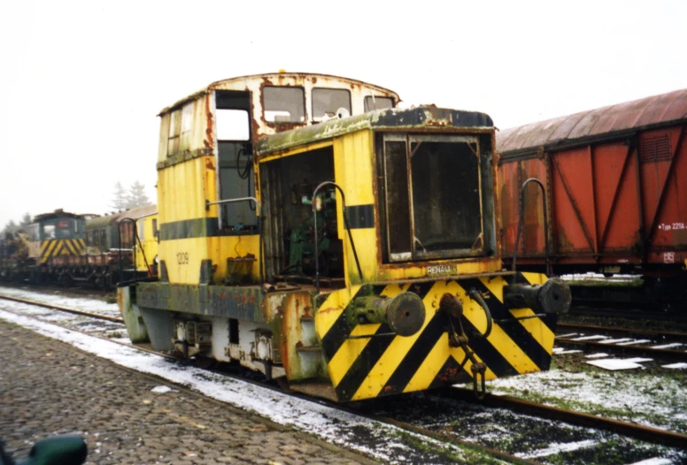 old and rusted train engine parked at a train station