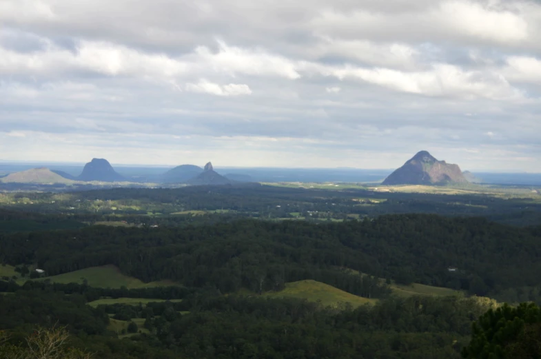 a scenic view of several hills in the distance