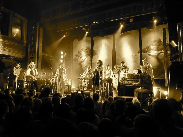 a band performing on stage while a crowd watches