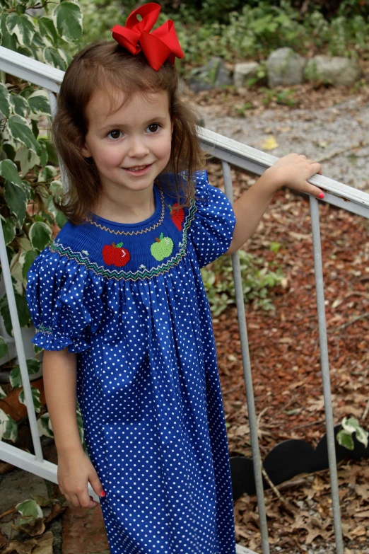 a little girl standing on stairs looking off to the side