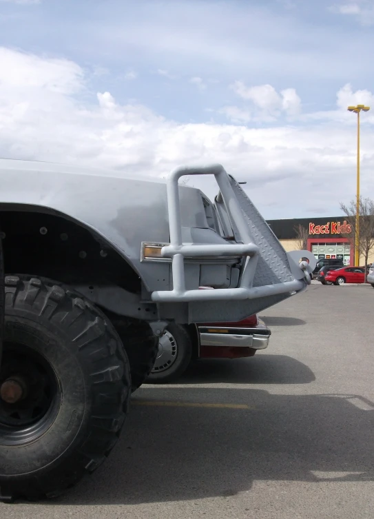 large gray pickup truck with a black flatbed with large tires