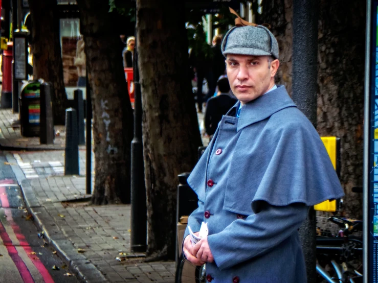 a man with a jacket standing on the side walk in the rain