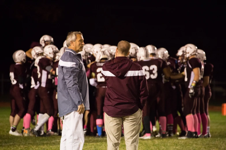 two men standing next to each other on a field