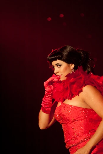 a woman with a red dress posing on stage