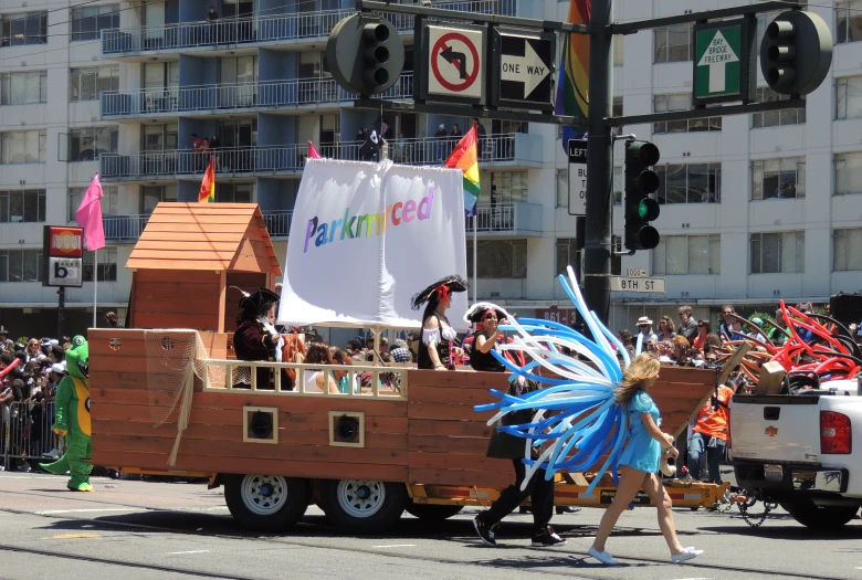 some people on the street with some very pretty costumed vehicles