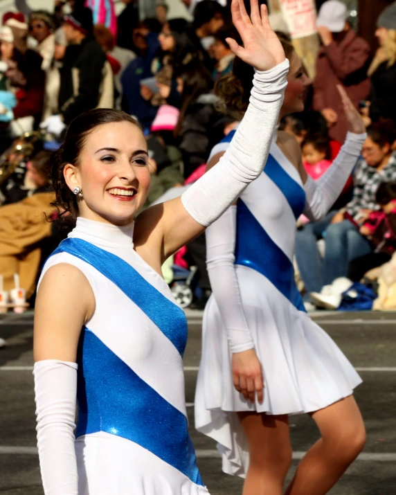 two beautiful young ladies with matching outfits, dancing