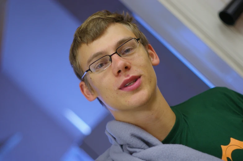 a young man in a green and gray shirt