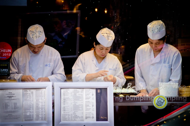 chefs cooking behind the counter in a restaurant