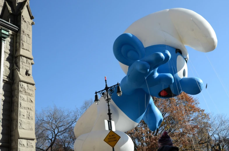 a giant balloon floating on top of a street