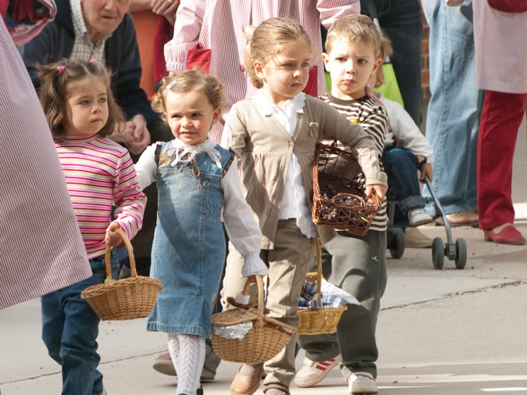 children with baskets and walking down the street