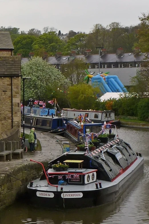 a narrow boat parked in a canal on the water