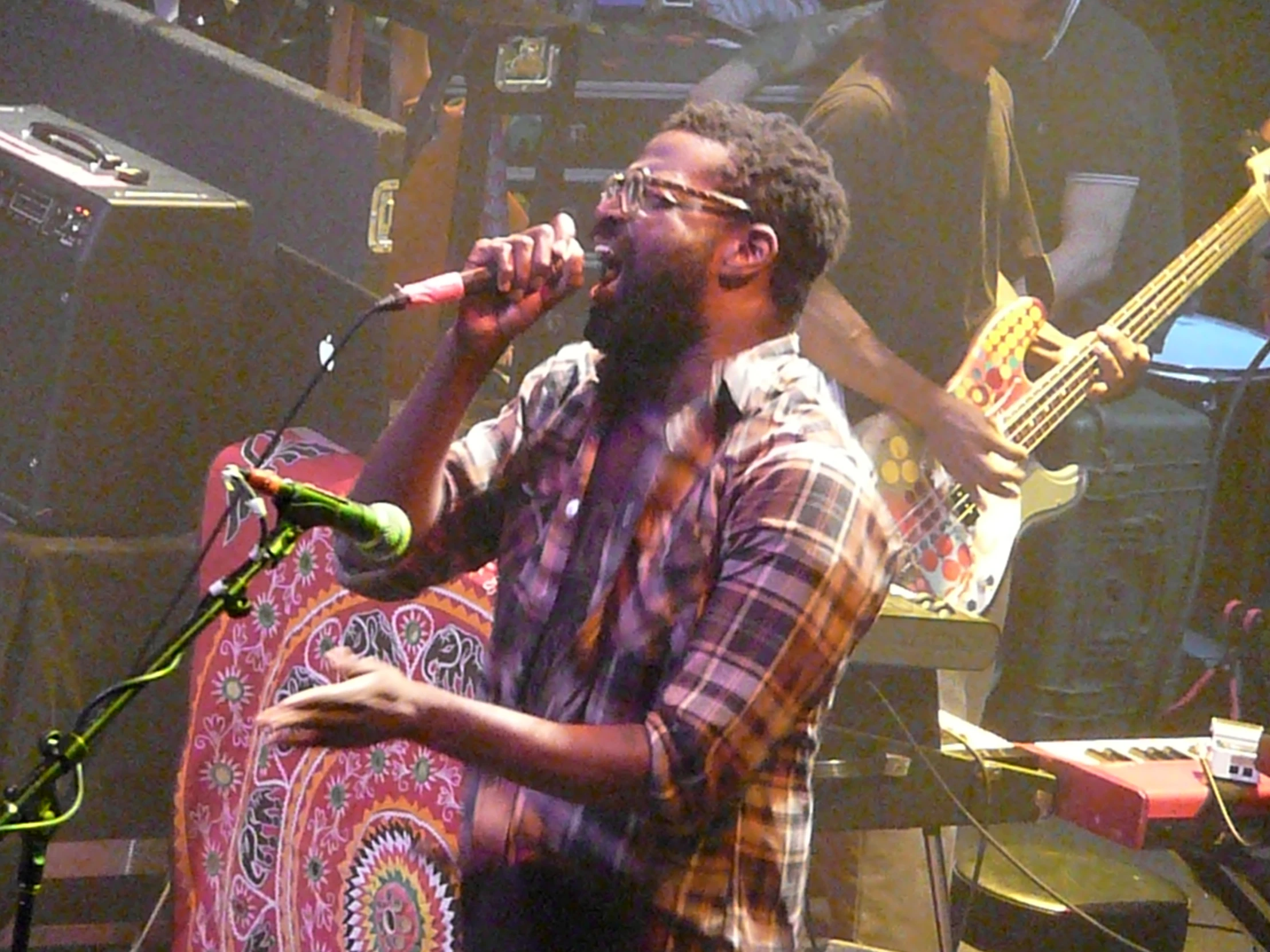 a man standing with a guitar and a microphone